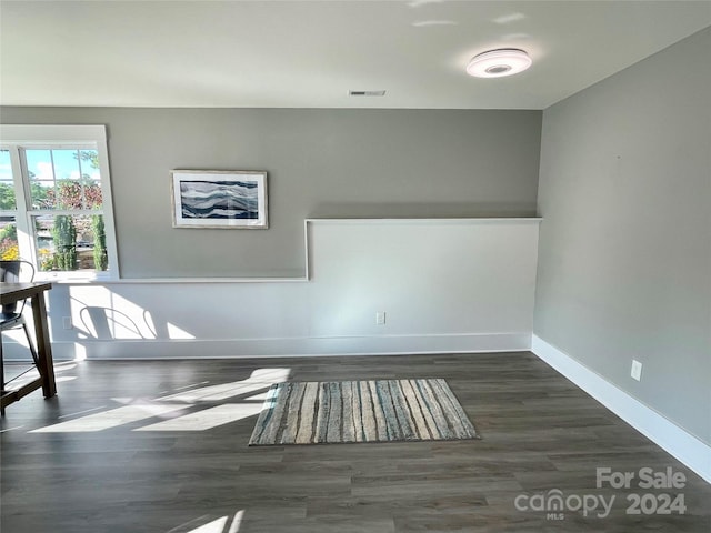 empty room with dark wood-type flooring