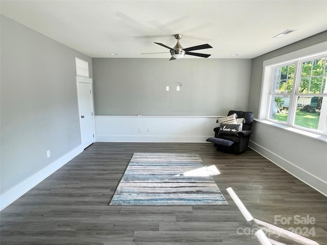 unfurnished room featuring dark hardwood / wood-style flooring and ceiling fan