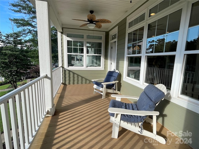 wooden terrace featuring ceiling fan