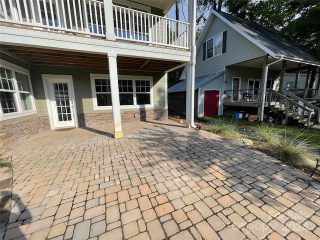 view of patio featuring a balcony