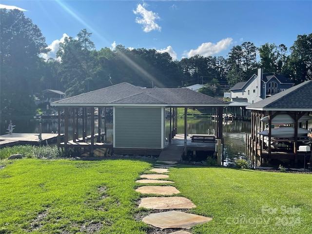 dock area featuring a water view and a yard