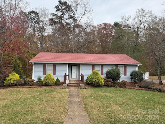 ranch-style house with a front lawn