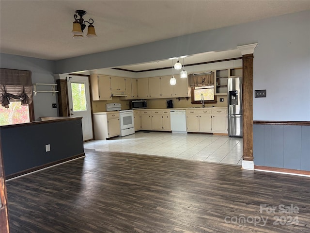 kitchen featuring appliances with stainless steel finishes, light wood-type flooring, and a healthy amount of sunlight