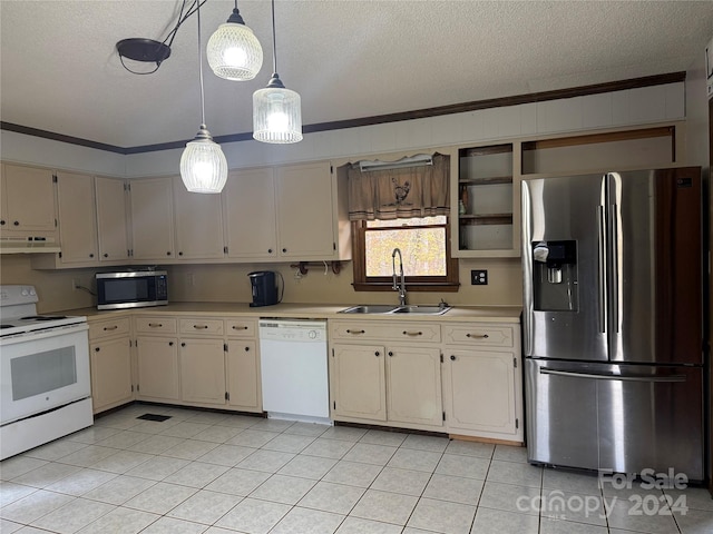 kitchen with a textured ceiling, stainless steel appliances, crown molding, sink, and pendant lighting