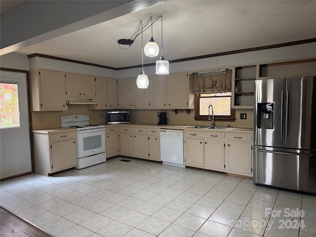 kitchen featuring sink, hanging light fixtures, cream cabinetry, appliances with stainless steel finishes, and ornamental molding