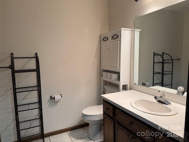 bathroom featuring tile patterned flooring, vanity, and toilet