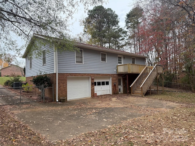 back of house featuring a garage and a wooden deck