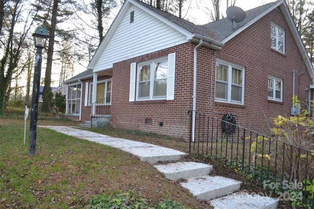 view of home's exterior with a lawn