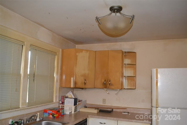 kitchen with white refrigerator and sink