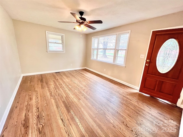 entrance foyer featuring baseboards, ceiling fan, and light wood-style floors