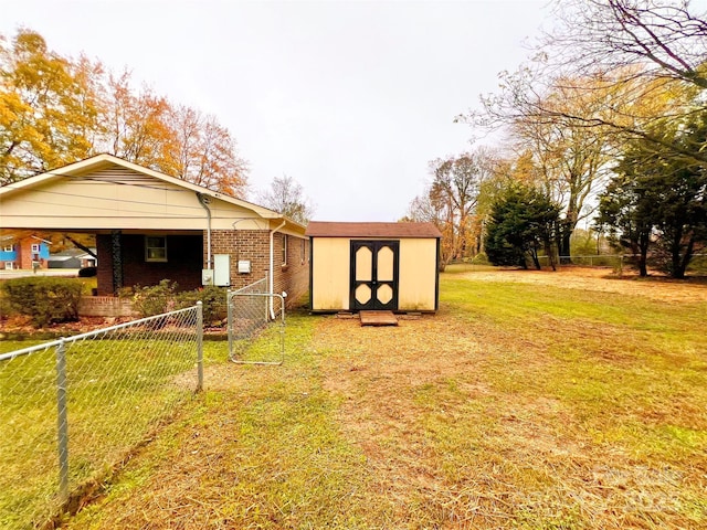 exterior space with brick siding, an outdoor structure, fence, a shed, and a front yard