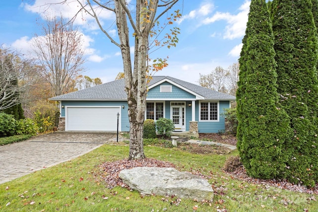 view of front of home featuring a garage and a front lawn