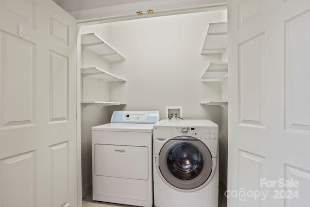 clothes washing area featuring independent washer and dryer