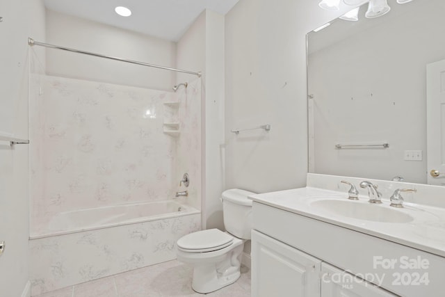 full bathroom with toilet, tile patterned flooring, vanity, and tiled shower / bath