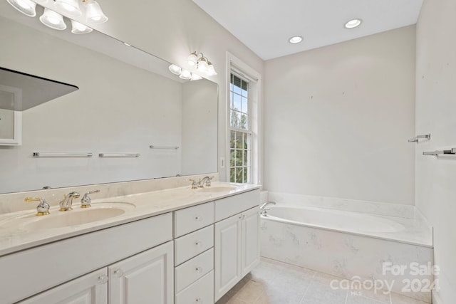 bathroom with tile patterned floors, vanity, and a bath