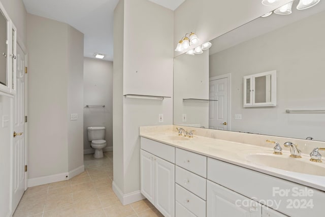 bathroom with tile patterned floors, vanity, and toilet