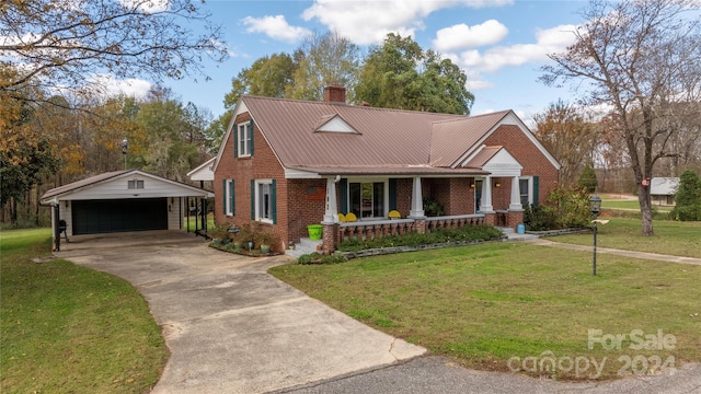 view of front of house with covered porch, a garage, an outdoor structure, and a front lawn