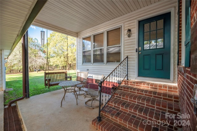 exterior space with a lawn and a porch