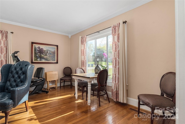 interior space featuring wood-type flooring and ornamental molding