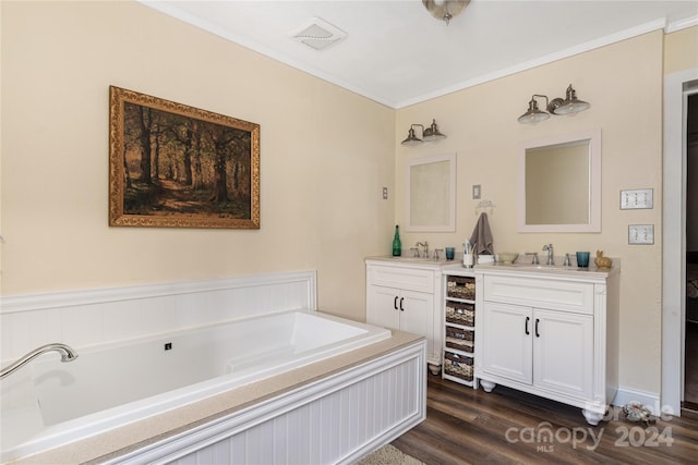 bathroom with a bath, wood-type flooring, vanity, and ornamental molding