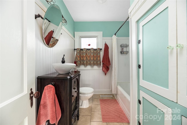 full bathroom with tile patterned floors, shower / bath combo, toilet, and vanity