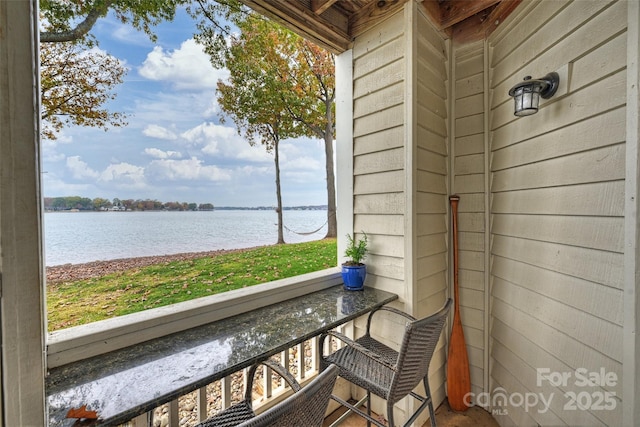 balcony featuring a water view