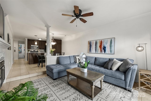 tiled living room with decorative columns, ceiling fan, ornamental molding, and a fireplace