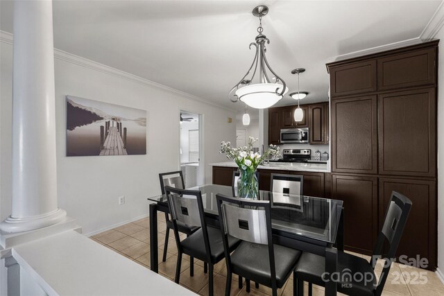 tiled dining space with crown molding and ornate columns