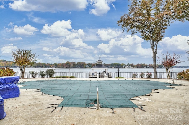 view of pool featuring a water view, a patio, and a gazebo