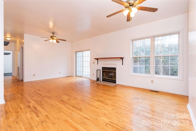 unfurnished living room featuring ceiling fan and light hardwood / wood-style flooring