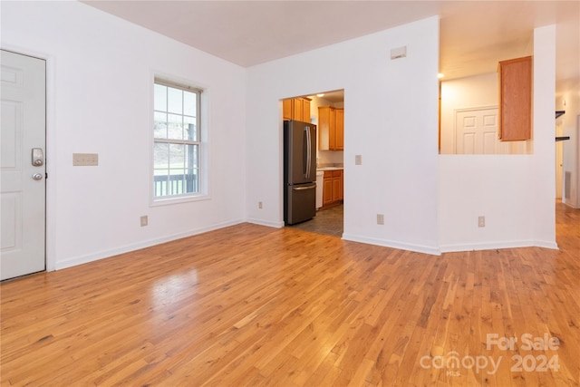 unfurnished living room with light wood-type flooring