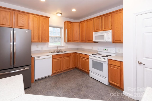 kitchen featuring white appliances and sink