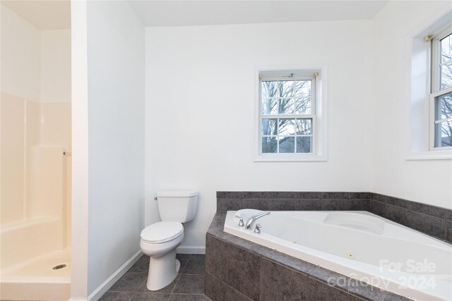 bathroom featuring separate shower and tub, tile patterned flooring, a healthy amount of sunlight, and toilet