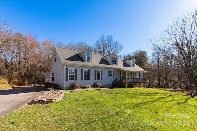 cape cod-style house with covered porch and a front lawn