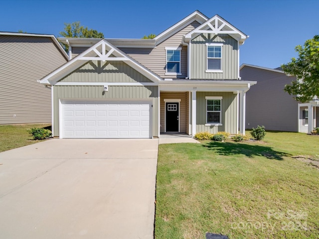 craftsman house featuring a front yard and a garage