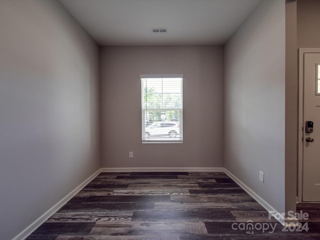 empty room with dark wood-type flooring