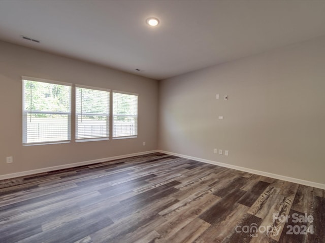 spare room with dark hardwood / wood-style flooring