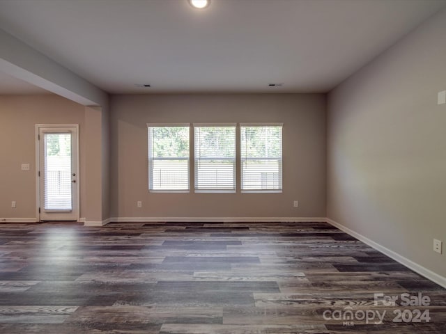 unfurnished room featuring dark hardwood / wood-style flooring