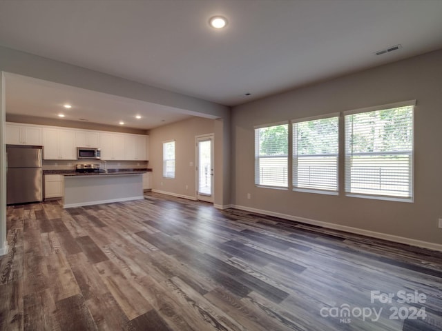 unfurnished living room with dark hardwood / wood-style flooring