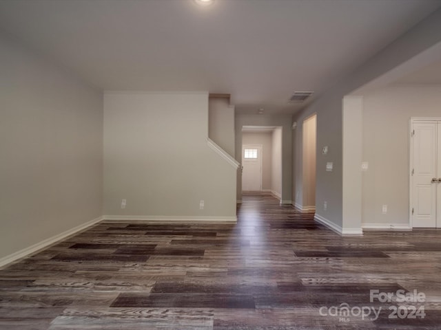 empty room with dark hardwood / wood-style flooring