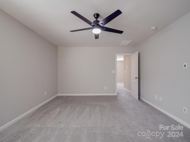 spare room with ceiling fan and light colored carpet