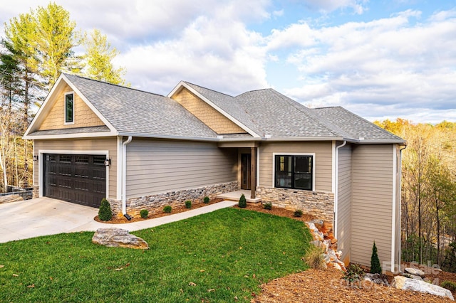 craftsman inspired home featuring a front yard and a garage