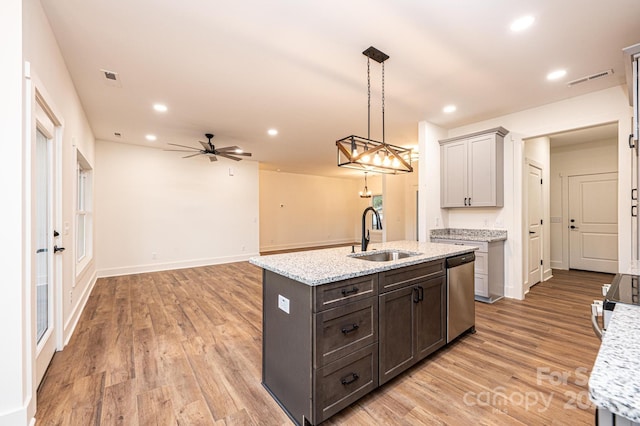 kitchen featuring ceiling fan, sink, stainless steel dishwasher, and light hardwood / wood-style flooring