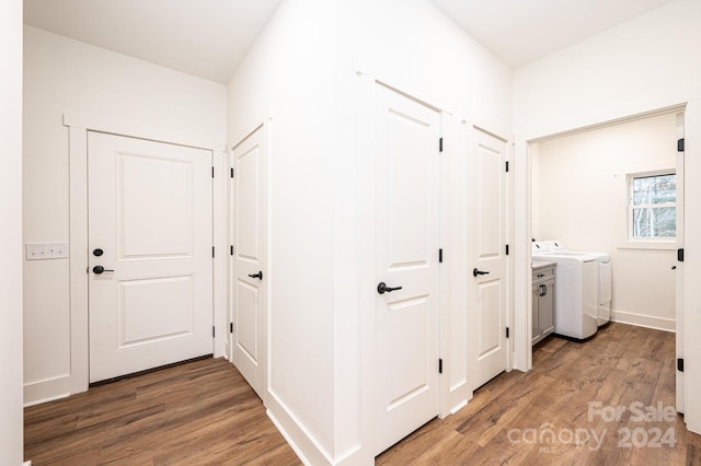 hall featuring wood-type flooring and washing machine and clothes dryer