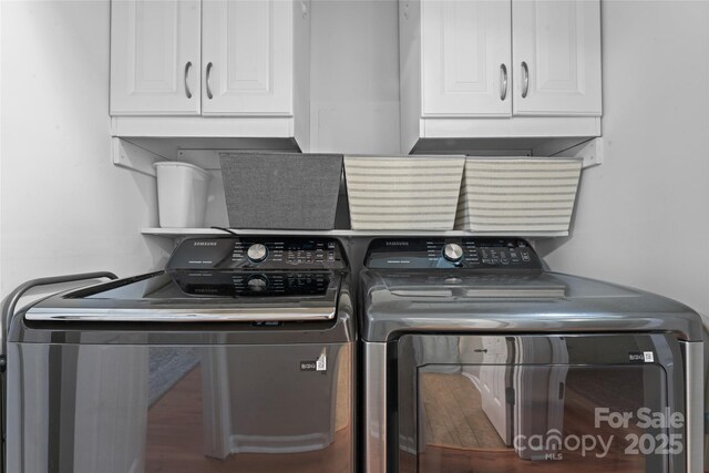 laundry room featuring cabinet space and washing machine and clothes dryer