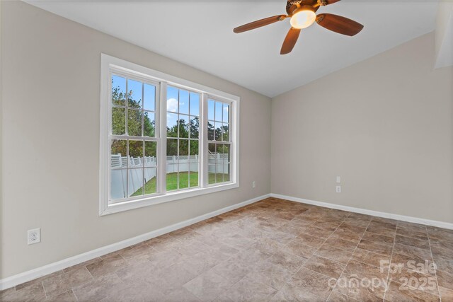 unfurnished room featuring baseboards and a ceiling fan