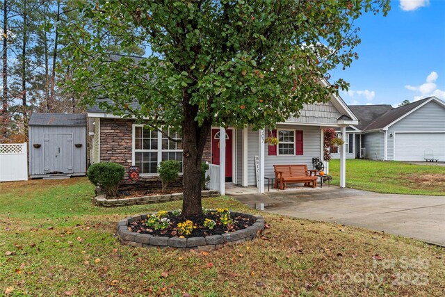 view of front of home featuring driveway, a front lawn, an attached garage, and stone siding