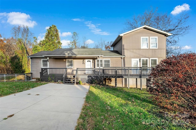 view of front of property with a front yard and a wooden deck