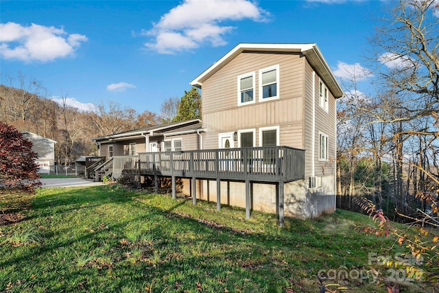 rear view of property with a yard, central AC unit, and a deck