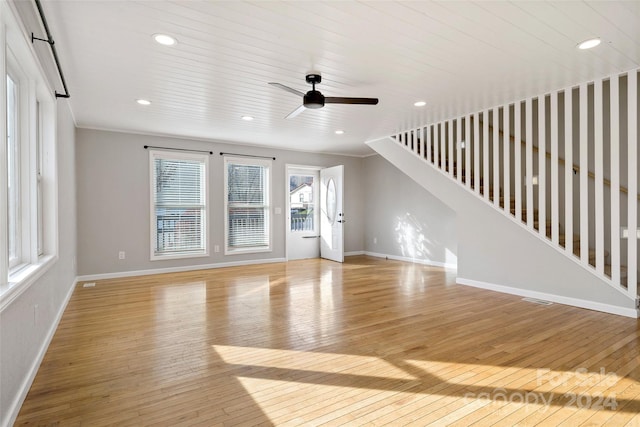 unfurnished living room with ceiling fan and light wood-type flooring